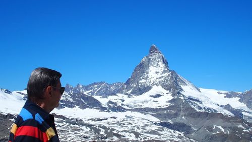 Man looking at snowcapped mountain 