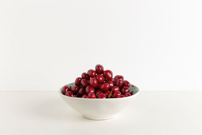 Close-up of strawberries in bowl against white background