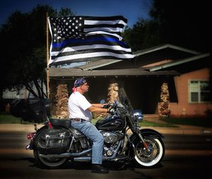 Man riding motorcycle against sky