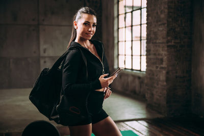 Portrait of young woman using mobile phone