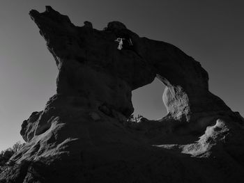 Low angle view of rock formation against sky
