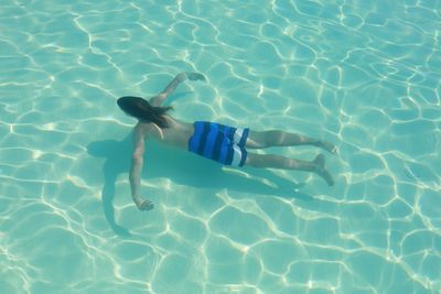High angle view of young woman swimming in pool