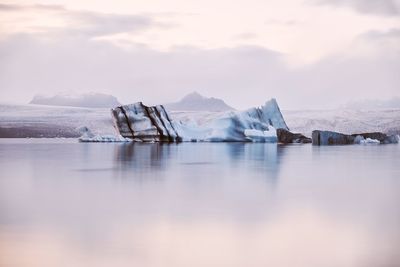 Glaciers on lake against sky