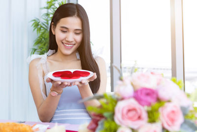 Woman holding red roses