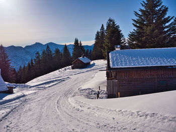 Snow covered landscape against sky