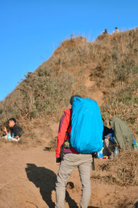 Rear view of people walking on land