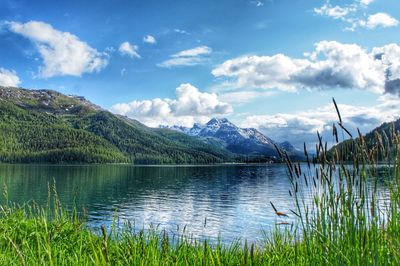 Scenic view of lake and mountains against sky