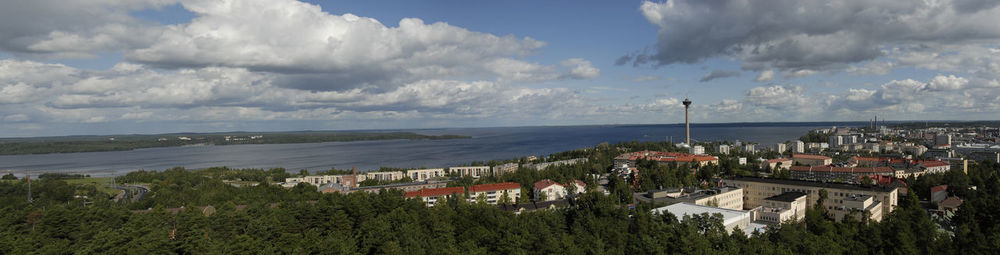 Panoramic view of town by sea against sky