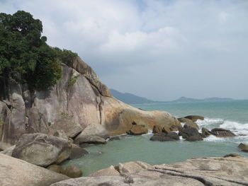 Scenic view of rocky mountains and sea against sky