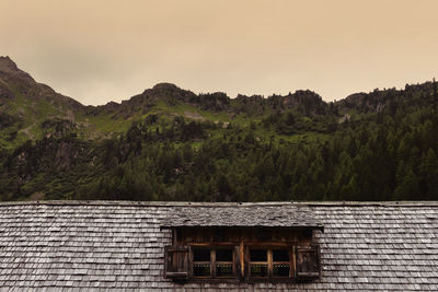 House on mountain against sky