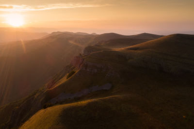 Scenic view of mountains against sky during sunset