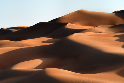 Close-up of sand dune in desert against sky