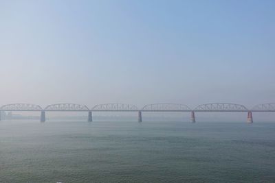 Bridge over river against clear sky