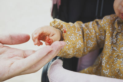 Close-up of baby holding hands