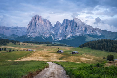 Scenic view of field and mountains against sky