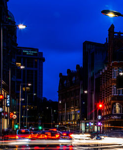 Light trails on city street and buildings at night