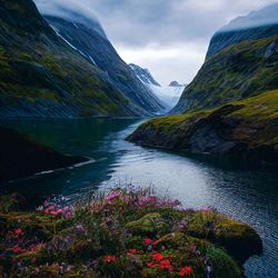 Scenic view of lake and mountains against sky