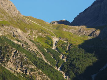 Scenic view of mountains against clear blue sky