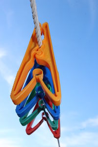 Low angle view of poles against blue sky