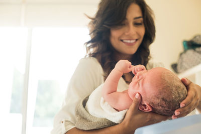 Happy mother with baby at home