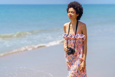 Young woman standing at beach