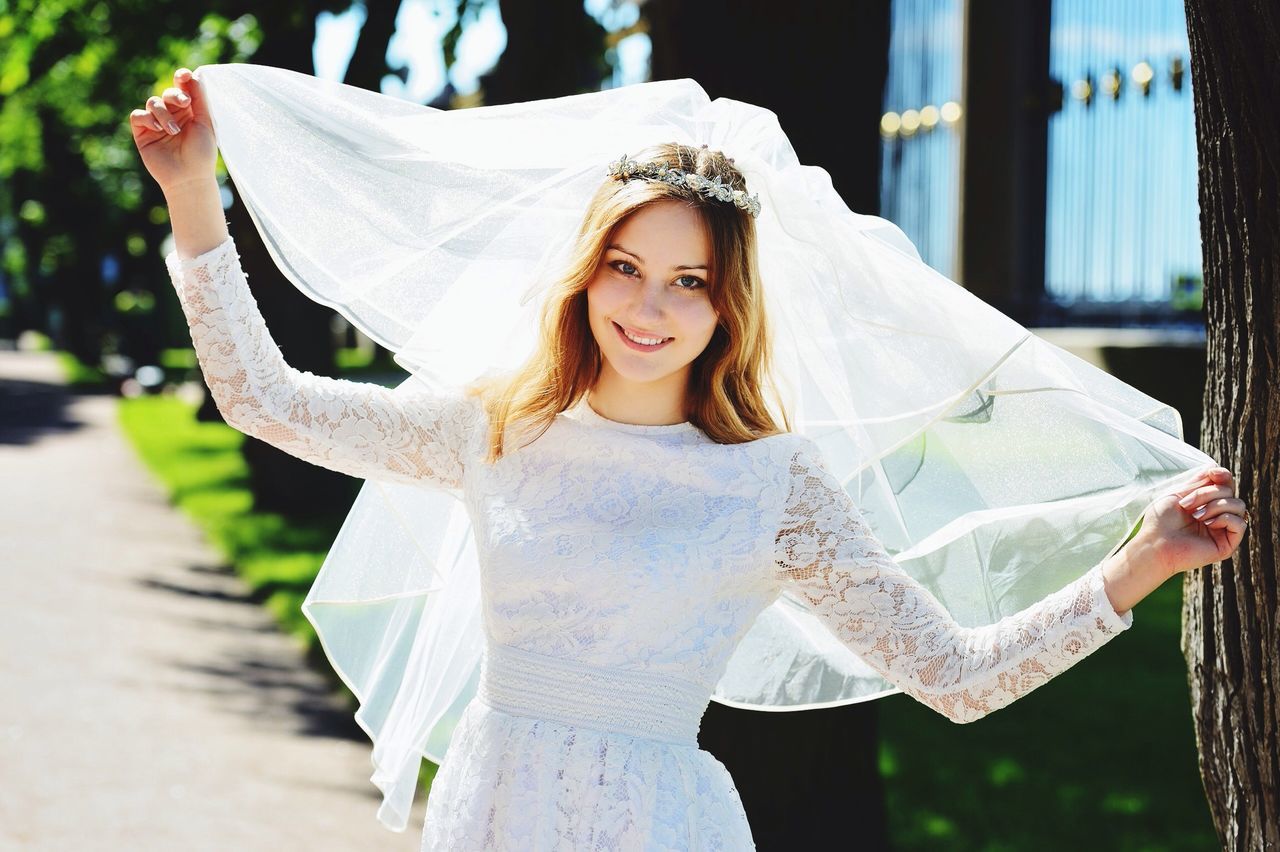 focus on foreground, holding, close-up, lifestyles, flower, front view, day, person, childhood, white color, leisure activity, outdoors, creativity, portrait, art and craft, art, girls, human representation