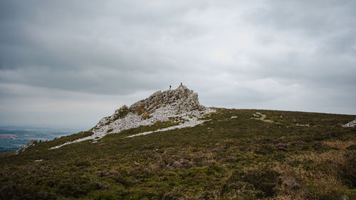 Scenic view of rocks on land against sky