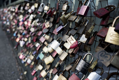 Close-up of padlocks hanging on railing