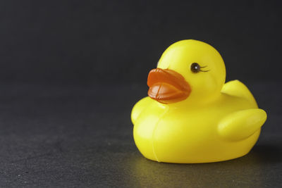 Close-up of yellow toy over black background