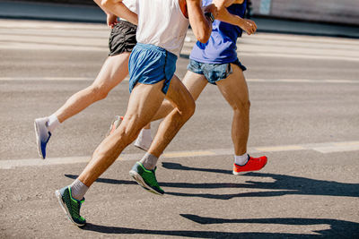 Low section of people running on road