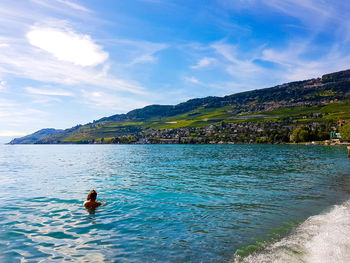 Man surfing in sea against sky