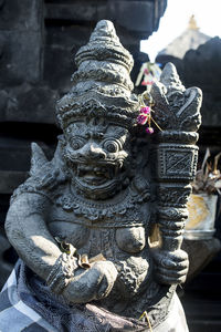 Close-up of buddha statue against building