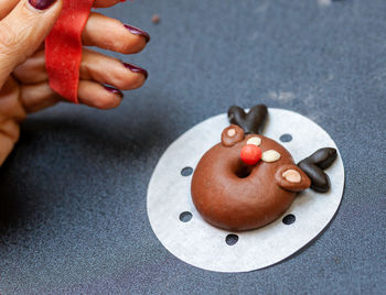 Cropped hand of person holding food on table