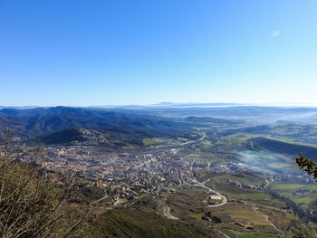 High angle view of land against clear blue sky