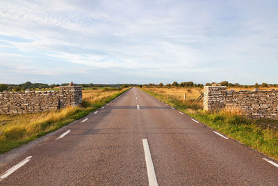 Country road straight to the horizon and karl x gustavs mur on oland, sweden