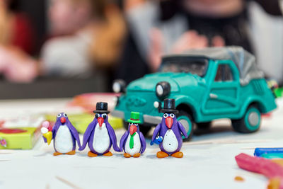 Close-up of figurines and toy car on table