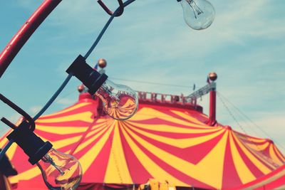 Low angle view of amusement park ride against sky