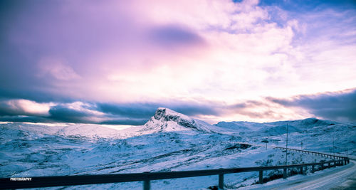 Scenic view of snowcapped mountains against sky during sunset