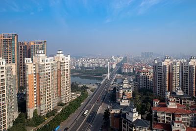 High angle view of street amidst buildings in city against sky