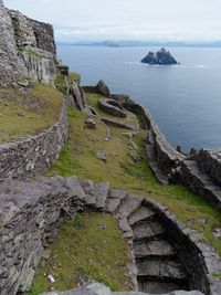 High angle view of rocks and sea against sky