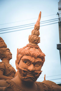 Low angle view of statue against sky