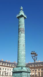 Low angle view of column against blue sky