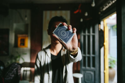 Man holding up a card towards camera