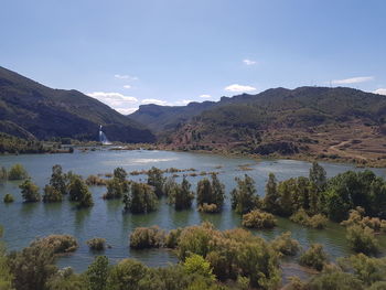 Scenic view of lake and mountains against sky