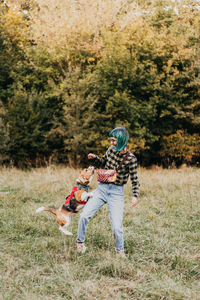 Rear view of woman standing on grassy field
