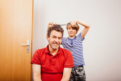 Portrait of father holding baby at home