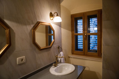 Small bathroom with mirror and sink and window