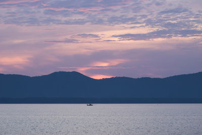 Scenic view of silhouette mountains against sky during sunset