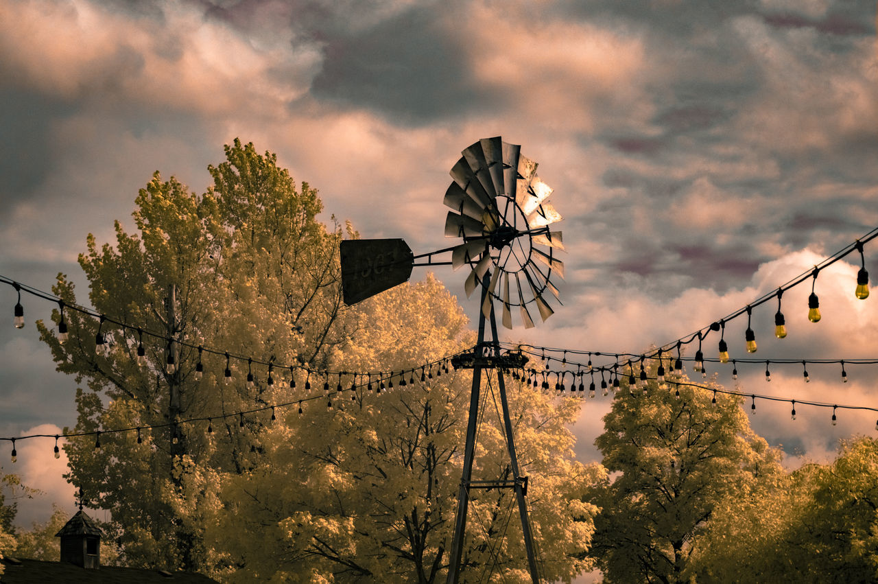 sky, tree, cloud - sky, plant, nature, renewable energy, alternative energy, environmental conservation, sunset, architecture, built structure, technology, fuel and power generation, wind turbine, environment, no people, turbine, low angle view, wind power, outdoors