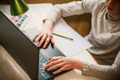 Midsection of woman using laptop